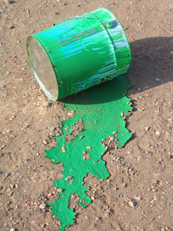 bucket of green paint with spill