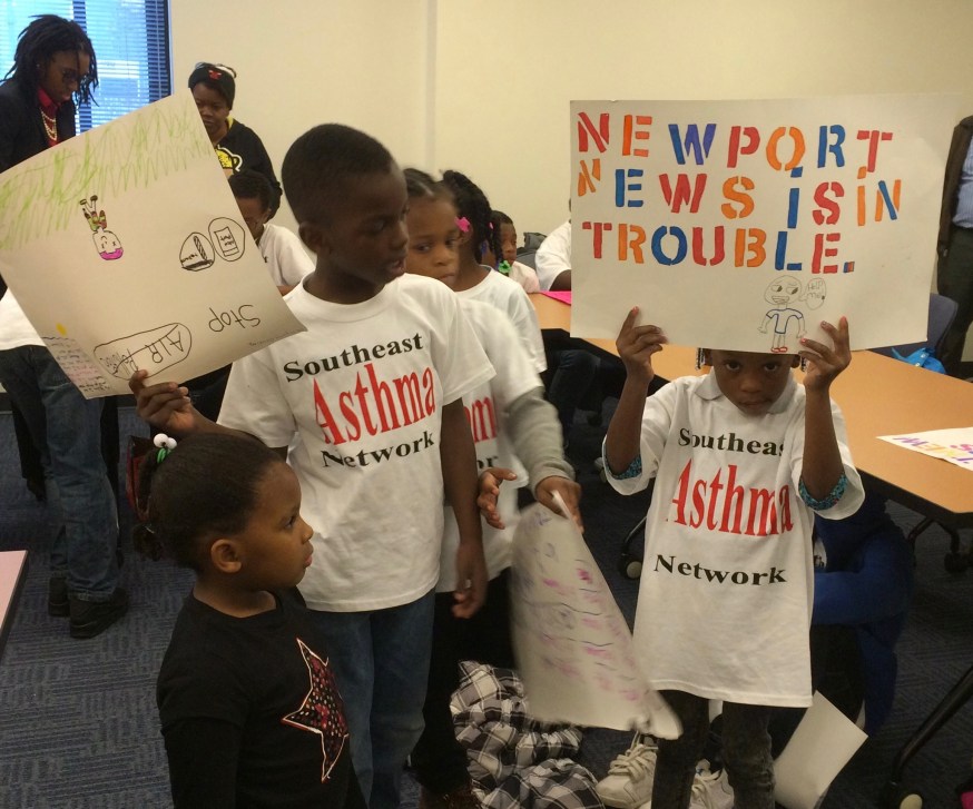 children holding signs, wearing T-shirts that read "Southeast asthma network"