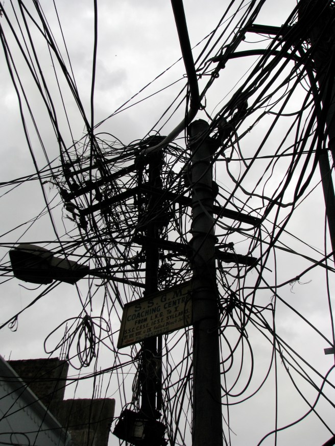 Tangled electric distribution wires illustrate the problems caused by poor grid planning
