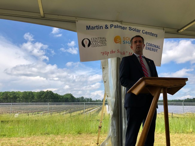 Virginia Governor Ralph Northam standing in front of a new solar farm.