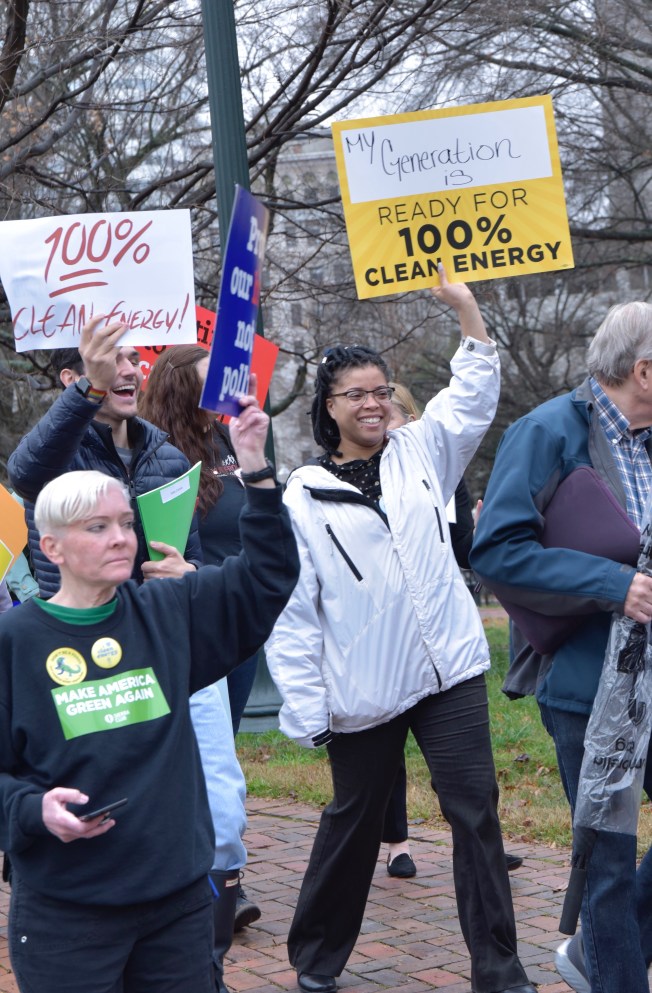 advocates holding clean energy signs