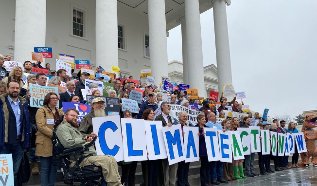 People gathered with signs supporting climate action