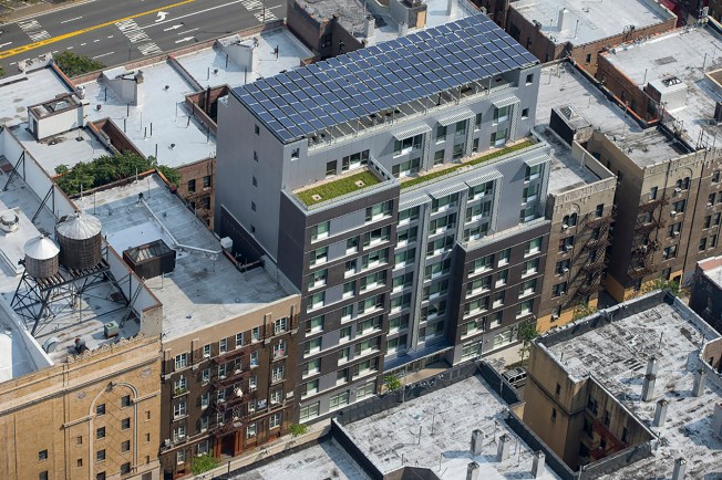 Apartment building with solar panels on the roof.